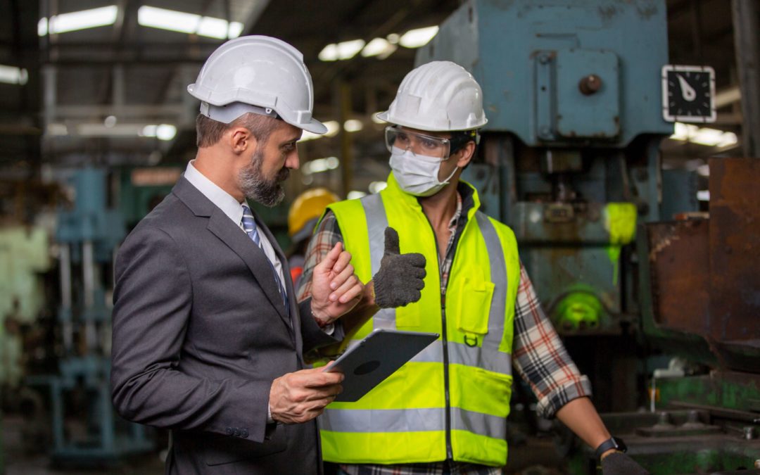 a production manager and shop floor worker discussing a process after going through a gemba walk