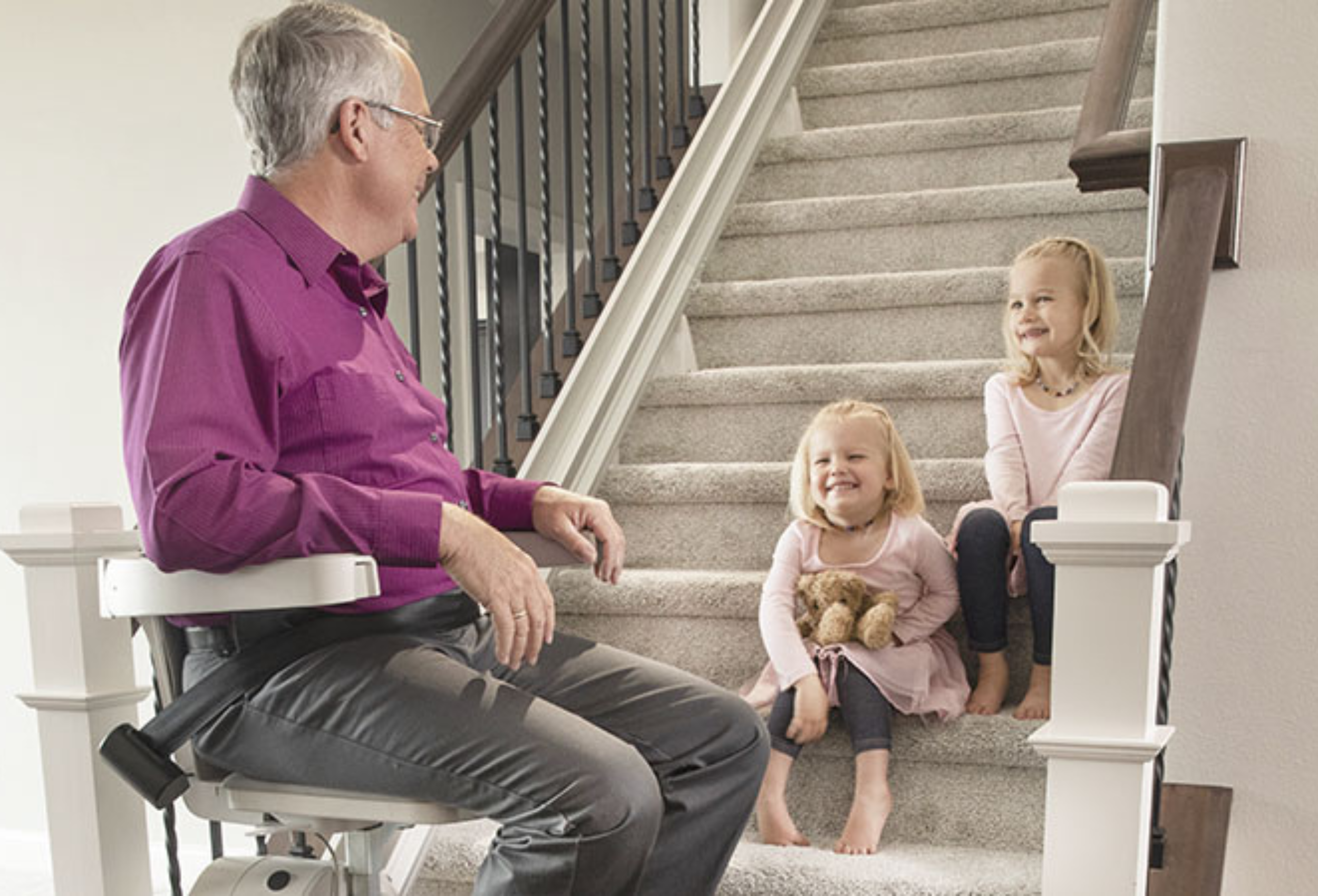 elderly man using a bruno living aid to go up the stairs